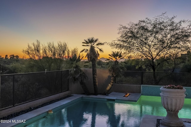 view of pool at dusk