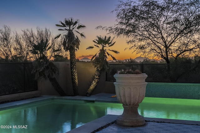 view of pool at dusk