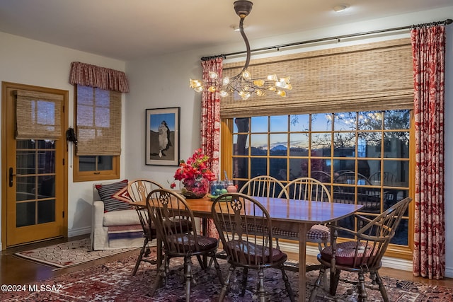 dining room with hardwood / wood-style flooring and a chandelier