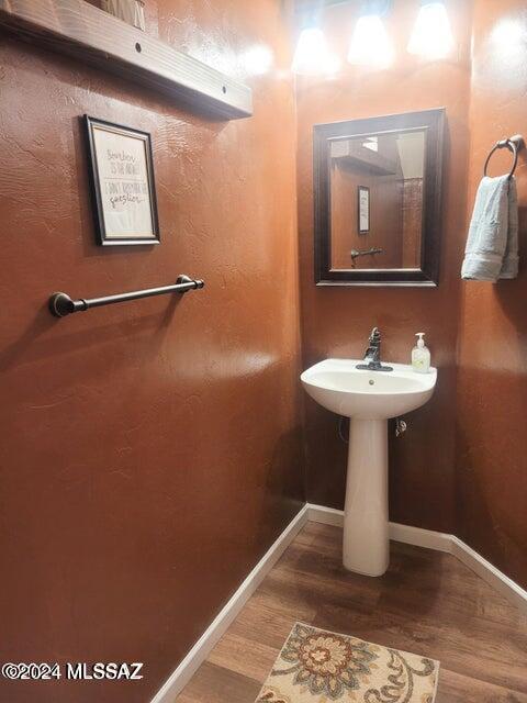 bathroom with hardwood / wood-style floors