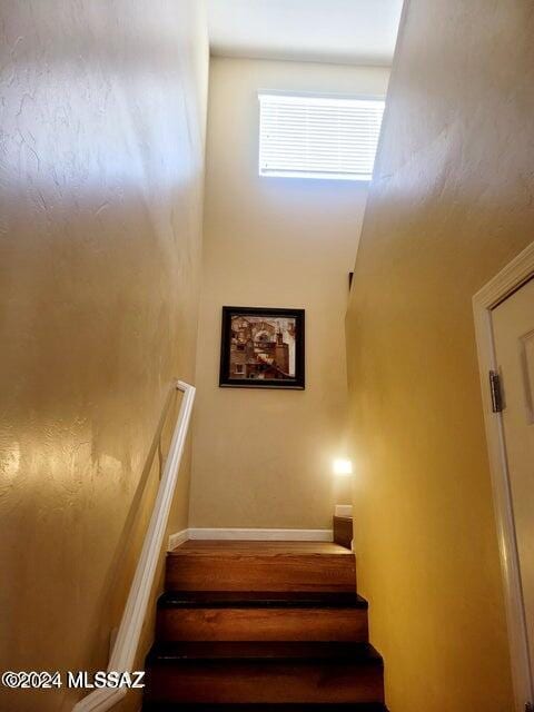 stairway featuring hardwood / wood-style flooring