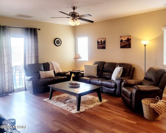 living room with hardwood / wood-style floors, ceiling fan, and a wealth of natural light