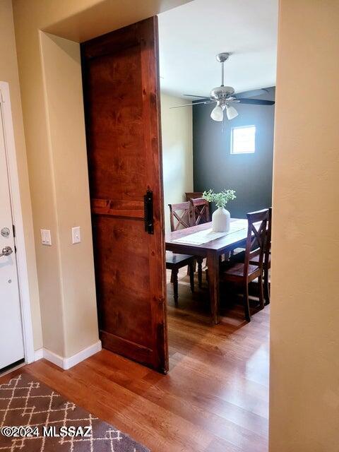 dining room with ceiling fan and wood-type flooring