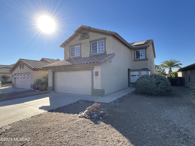 2655 W Desert Brook Ct, Tucson, AZ 85742 - view of front of house featuring a tile roof, stucco siding, solar panels, and concrete driveway