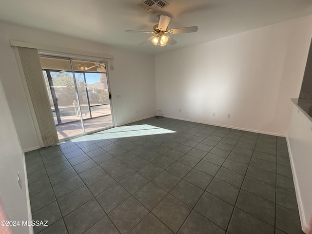 2655 W Desert Brook Ct, Tucson, AZ 85742 - unfurnished room with dark tile patterned flooring, a ceiling fan, and baseboards