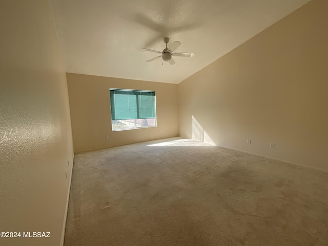 unfurnished room with lofted ceiling, light carpet, and ceiling fan