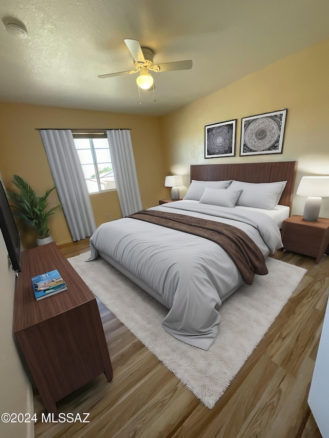 bedroom with vaulted ceiling, hardwood / wood-style floors, a textured ceiling, and ceiling fan