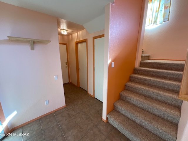 stairway featuring tile patterned floors