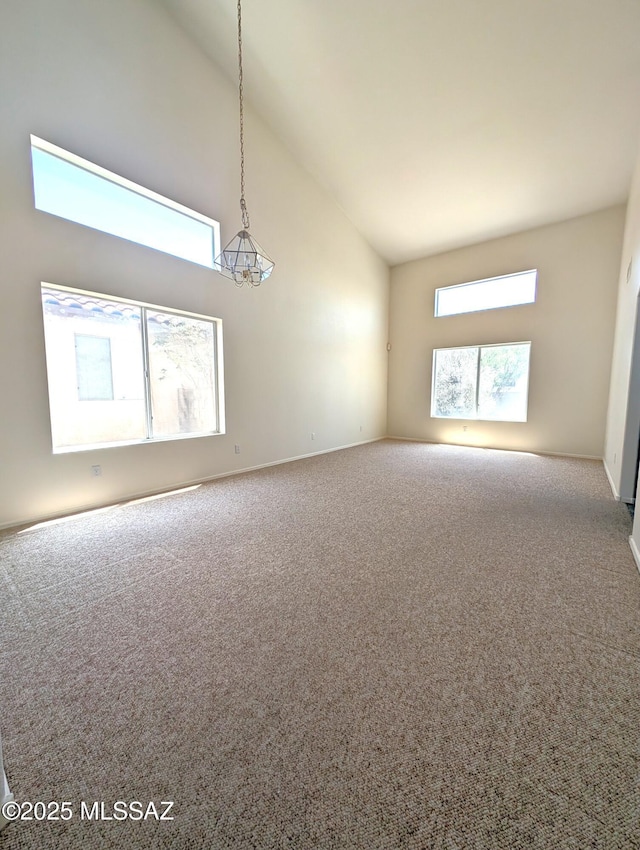2655 W Desert Brook Ct, Tucson, AZ 85742 - unfurnished room featuring high vaulted ceiling, carpet flooring, and baseboards