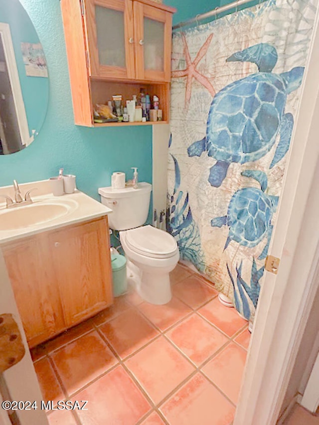 bathroom featuring tile patterned flooring, vanity, and toilet