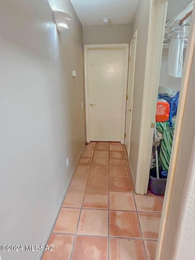 hallway featuring tile patterned flooring