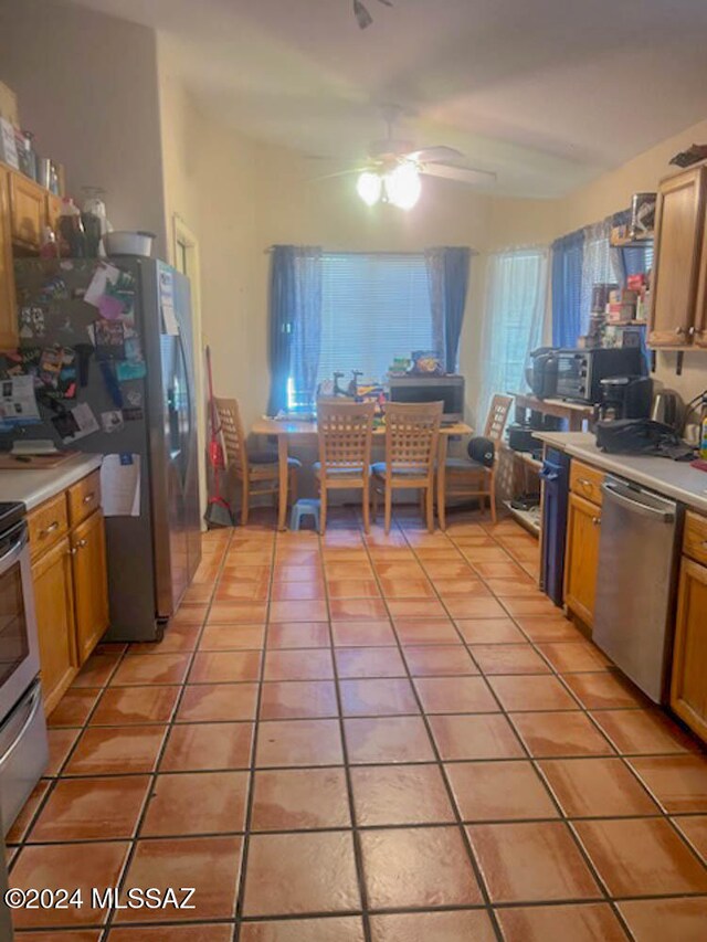 kitchen with stainless steel appliances, ceiling fan, and light tile patterned flooring