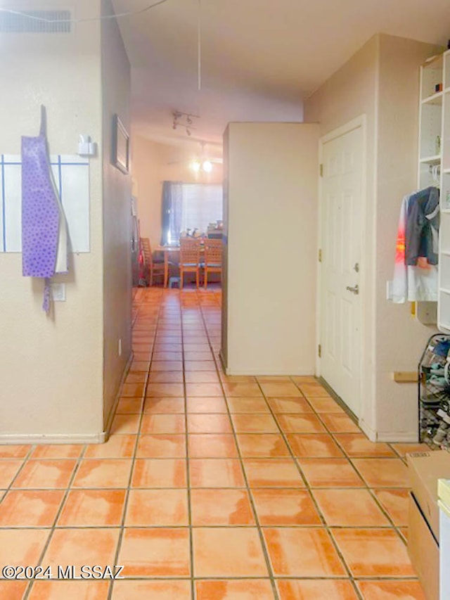 hallway with light tile patterned floors