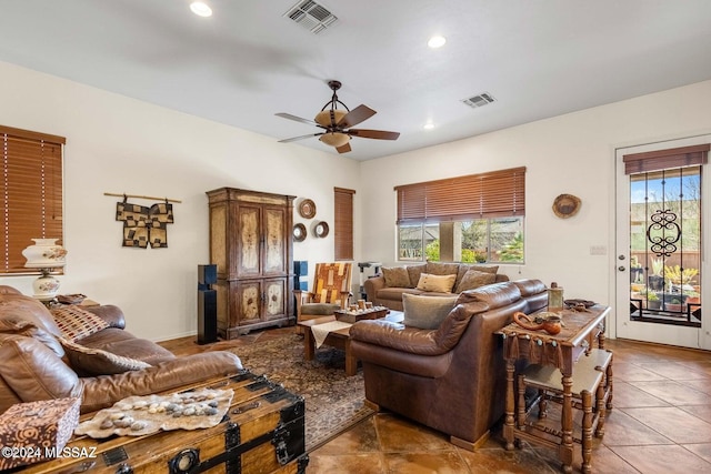 living room featuring tile patterned floors and ceiling fan