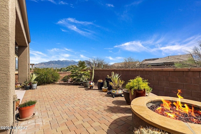 view of patio featuring a mountain view and an outdoor fire pit