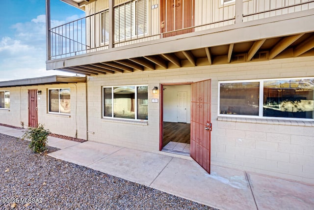 entrance to property with a patio area and concrete block siding