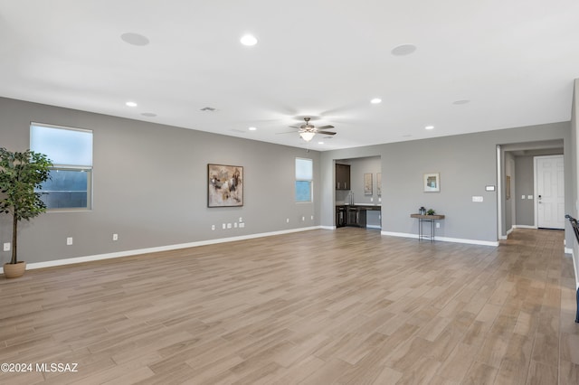 unfurnished living room featuring light hardwood / wood-style floors and ceiling fan