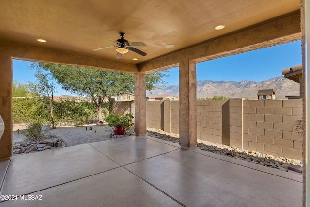 view of patio featuring ceiling fan and a mountain view