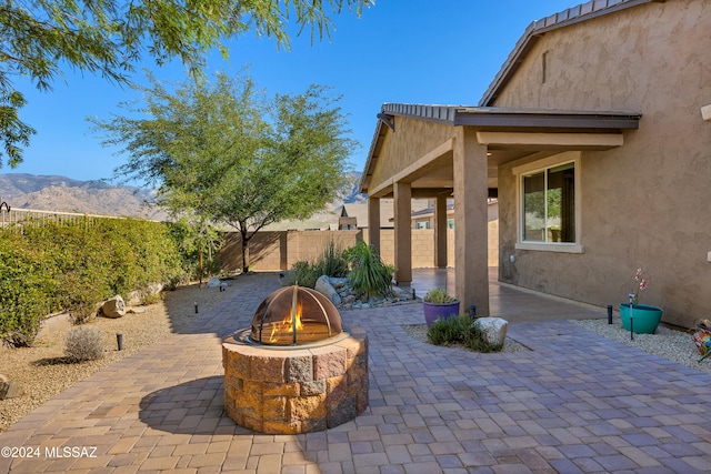 view of patio featuring a fire pit and a mountain view