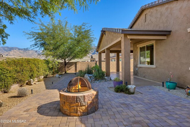 view of patio with ceiling fan and a mountain view