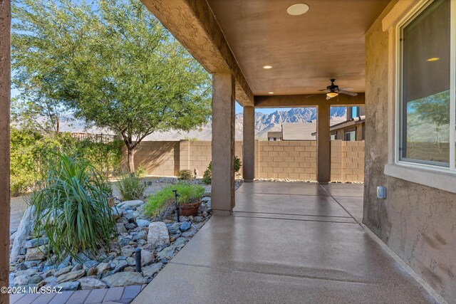 view of patio / terrace featuring a mountain view and a fire pit