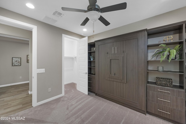 bedroom featuring ceiling fan, light carpet, and a closet