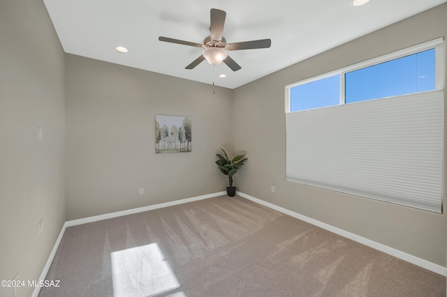 unfurnished room with carpet and ceiling fan