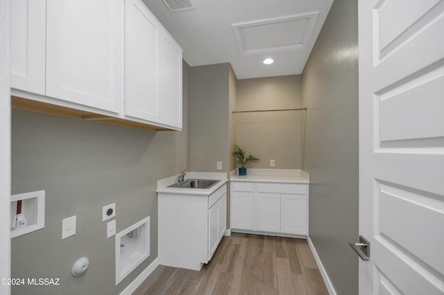 washroom featuring hookup for a washing machine, cabinets, sink, light hardwood / wood-style floors, and electric dryer hookup