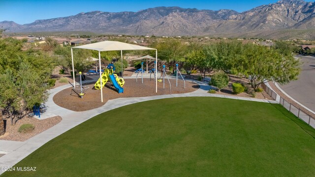 view of play area featuring a mountain view and a lawn