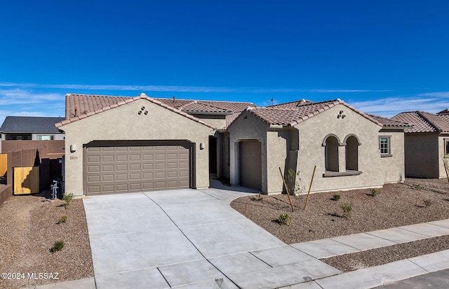 mediterranean / spanish-style home featuring a garage