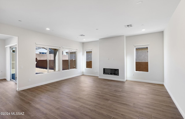 unfurnished living room with dark hardwood / wood-style floors