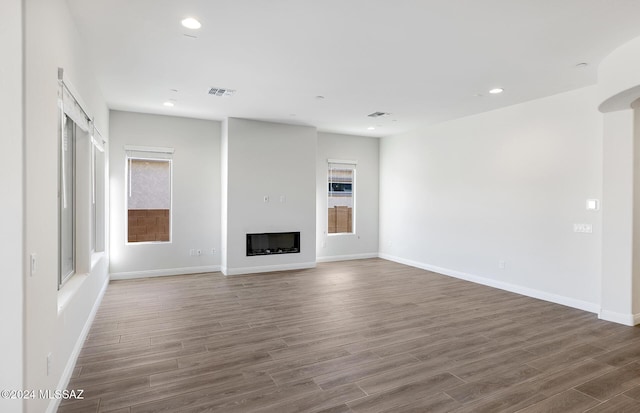 unfurnished living room featuring dark wood-type flooring