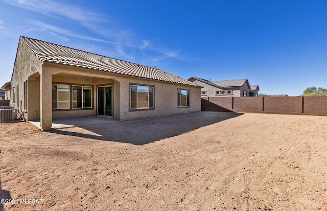 rear view of house featuring cooling unit and a patio