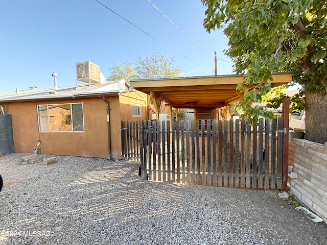 view of gate featuring a carport