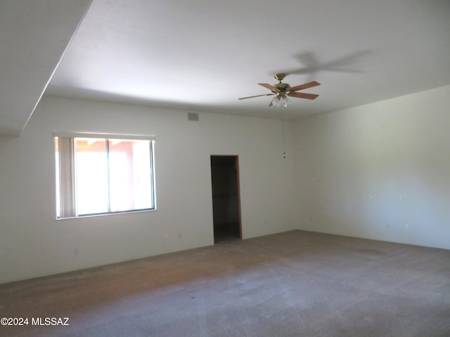 unfurnished room featuring ceiling fan and carpet floors