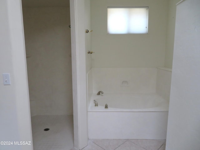 bathroom with a bathing tub and tile patterned floors