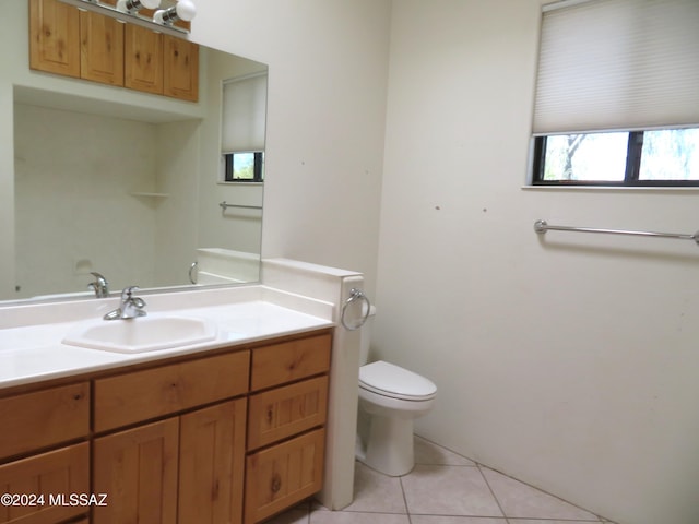 bathroom featuring tile patterned floors, vanity, and toilet