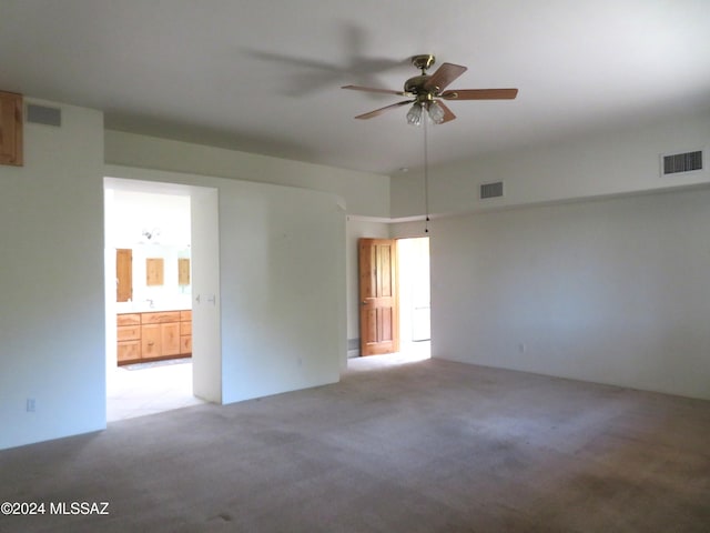 carpeted empty room featuring ceiling fan