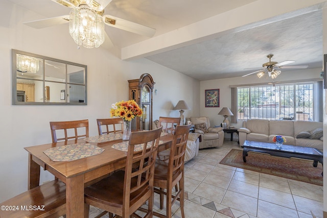 tiled dining space with beam ceiling and ceiling fan