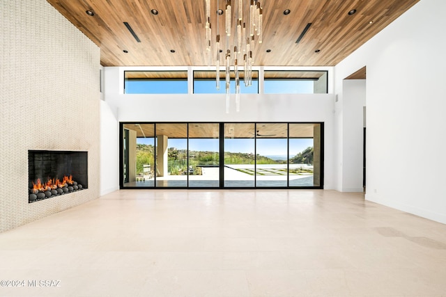 unfurnished living room featuring high vaulted ceiling, wooden ceiling, and a healthy amount of sunlight