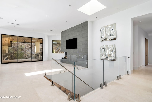 stairs with tile walls and a skylight