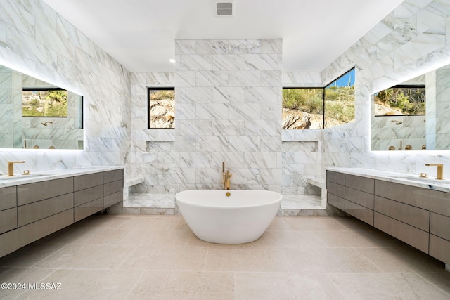 3569 E Secret Canyon Pl, Tucson, AZ 85718 - bathroom featuring tile walls, walk in shower, a freestanding tub, and two vanities