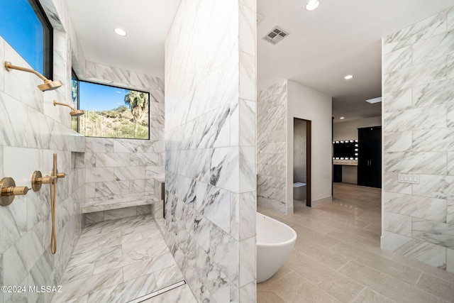 bathroom featuring tile walls and plus walk in shower