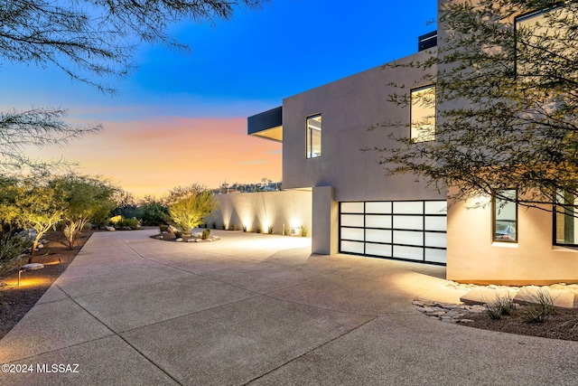 property exterior at dusk with a garage