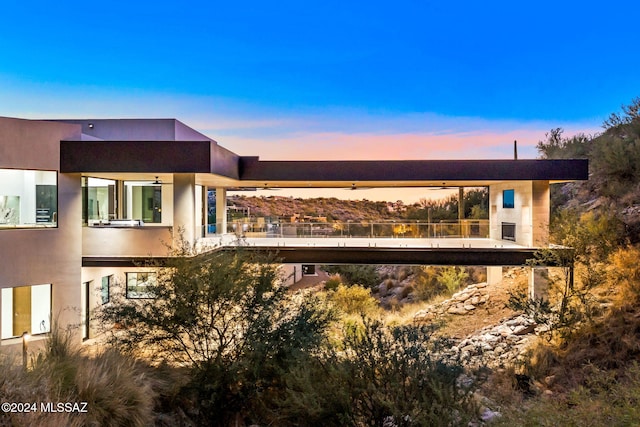 3569 E Secret Canyon Pl, Tucson, AZ 85718 - back of house at dusk with stucco siding