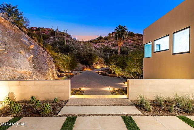 yard at dusk featuring a patio