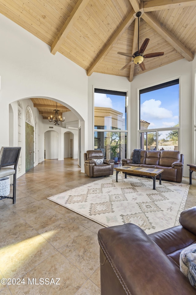 living room with ceiling fan with notable chandelier, beam ceiling, wooden ceiling, and high vaulted ceiling