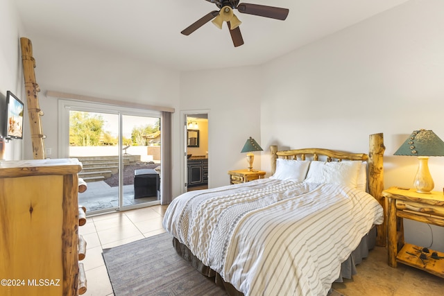 tiled bedroom with connected bathroom, access to outside, and ceiling fan