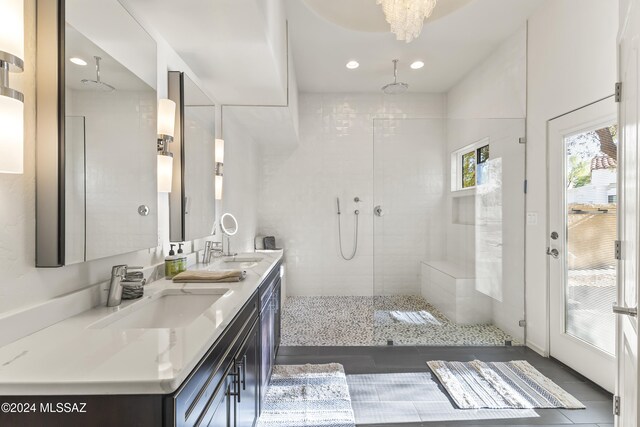 bathroom featuring a tile shower and vanity