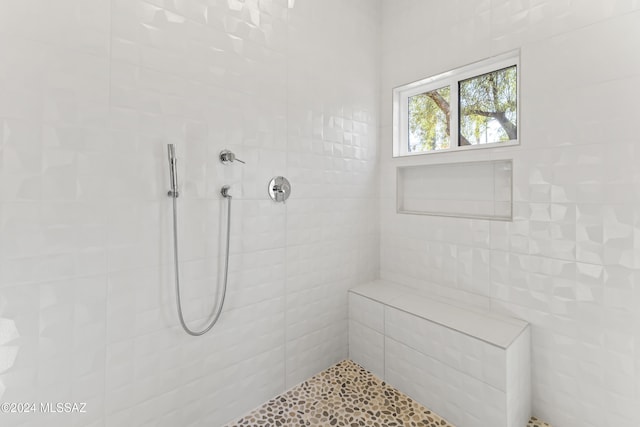 bathroom with tiled shower